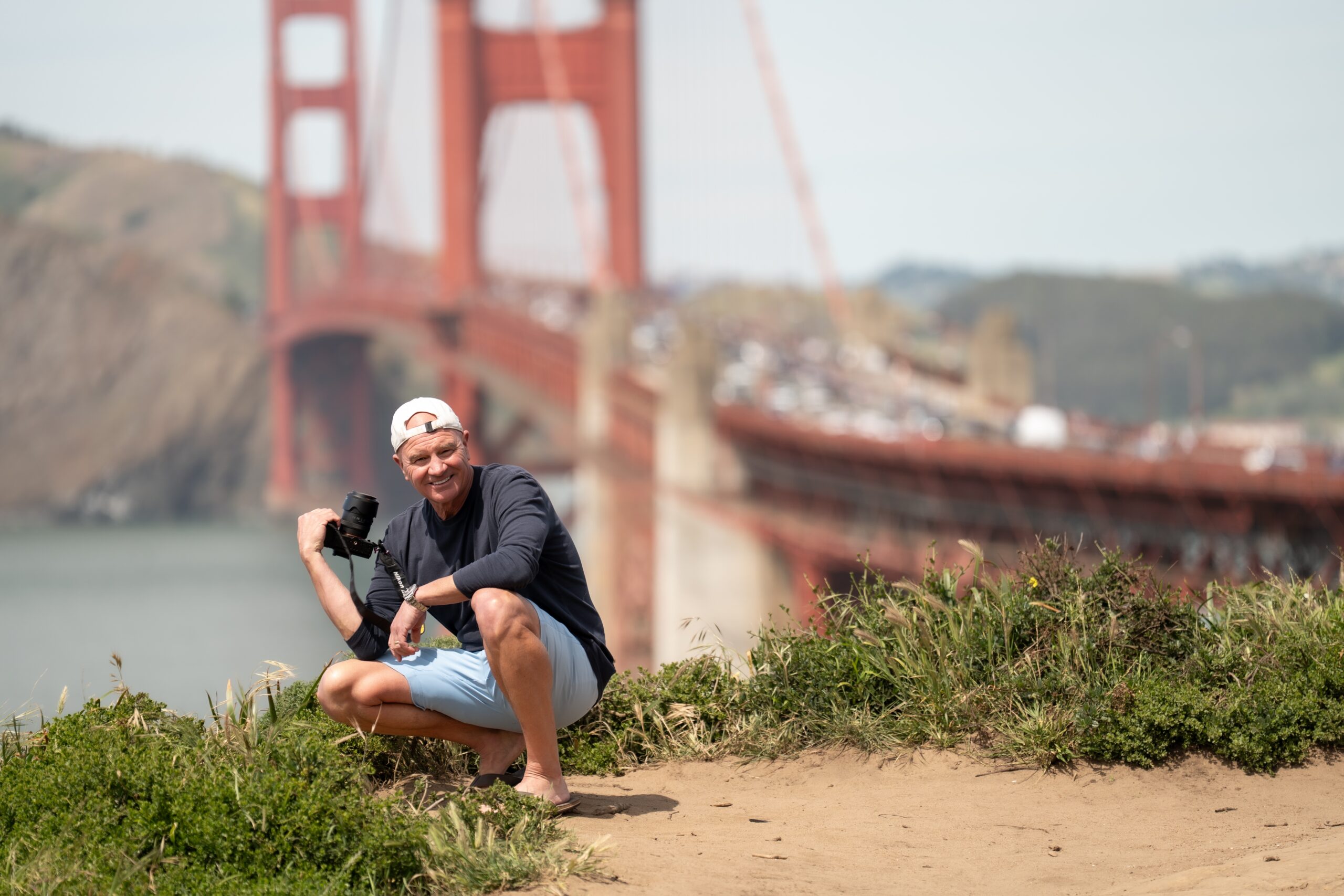 Chris Conner holding a camera at Golden Gate Bridge