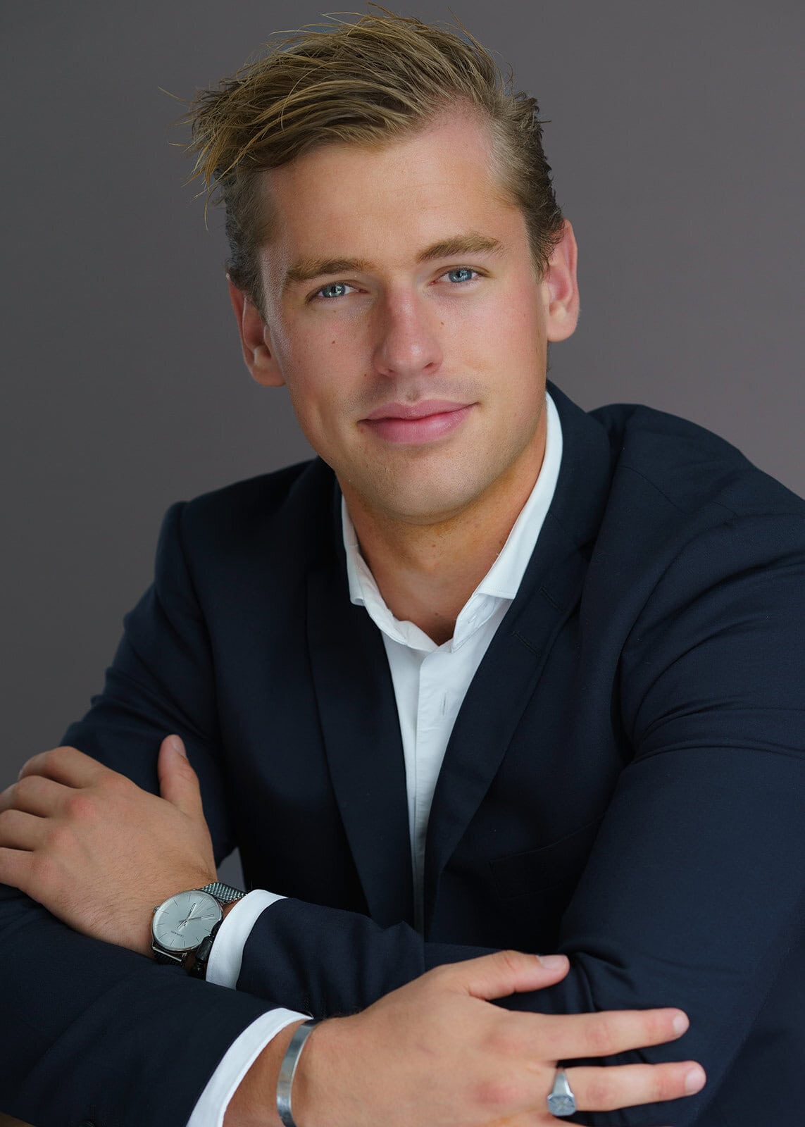 Professional headshot of a man in a navy blazer with folded arms, photographed by Chris Conner Photography in San Francisco
