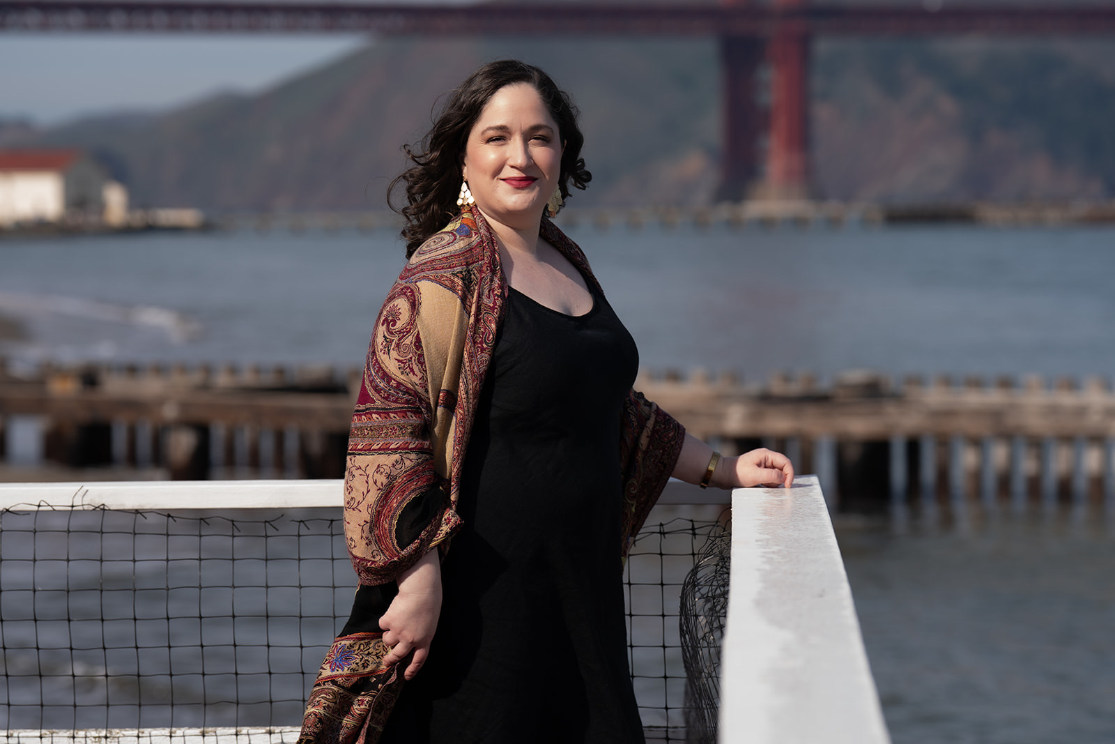 Headshot of a woman standing next to Golden Gate Bridge