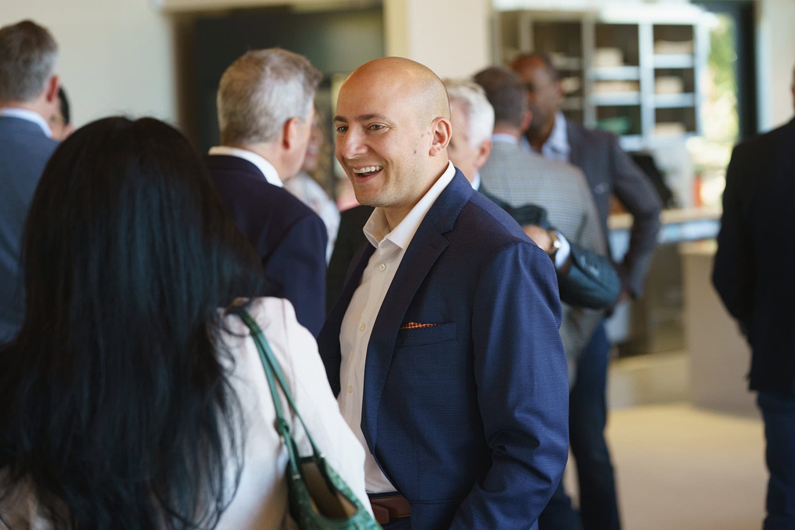 Photo of a man smiling at a corporate event