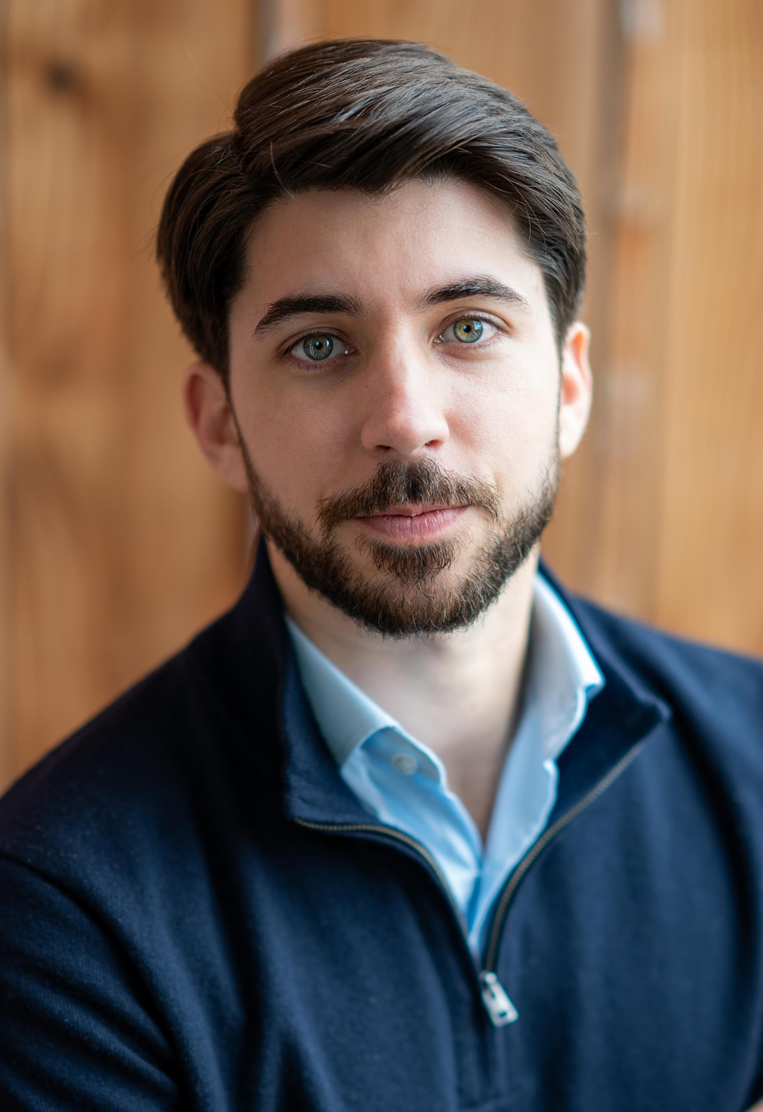 Professional headshot of a man in a navy sweater and light blue shirt, photographed in natural light by Chris Conner Photography in San Francisco