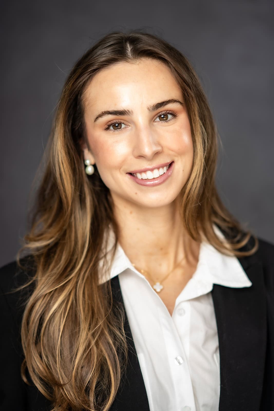 “Professional woman smiling in front of a gray backdrop — business headshot captured in San Francisco studio”